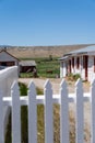 White picket fence gate leads to more historic buildings at Grant-Kohrs National Historic Royalty Free Stock Photo