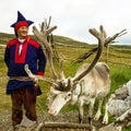 Deer and reindeer breeder dressed in national clothes the Sami in Honningsvag, Norway. The Sami are the people inhabiting the Arct