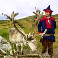 Deer and reindeer breeder dressed in national clothes the Sami in Honningsvag, Norway. The Sami are the people inhabiting the Royalty Free Stock Photo