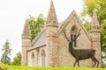 Deer sculpture with little church scotland