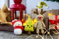 Deer, snowman and amigurumi herringbone on a wooden background. The concept of a cozy, magical Christmas and New Year