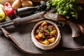 Deer stew in a bowl hunting weapon as a decoration Royalty Free Stock Photo