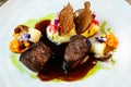 Deer tenderloin. Truffle-potato puree, porcini mushrooms, baked leek and carrot, juniper bread, port wine sauce Royalty Free Stock Photo