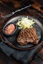 Deer venison steak with sea salt and salad. Wooden background. Top view