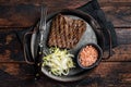 Deer venison steak with sea salt and salad. Wooden background. Top view