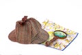 Deerstalker cap, magnifying glass and London map Royalty Free Stock Photo