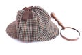 Deerstalker or Sherlock Holmes cap and vintage magnifying glass