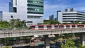Elevated Light Rail Train Passing Through Modern Cityscape Royalty Free Stock Photo