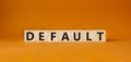Default symbol. Concept word Default on wooden cubes. Beautiful orange background. Business and Default concept. Copy space