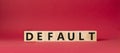 Default symbol. Concept word Default on wooden cubes. Beautiful red background. Business and Default concept. Copy space