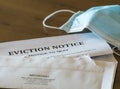 Official legal eviction order or notice to renter or tenant of home with face mask