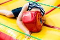 Defeated boy lying in a boxing helmet