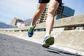 Defeating the road. Cropped images or a runners shoes as he glides past.