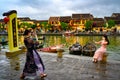 Hoi An, Vietnam, young beautiful women taking photos on canal in tourist destination Hoi An, Vietnam Royalty Free Stock Photo