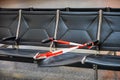 Defective broken seat secured with a red and white plastic barrier tape in the waiting area of an airport