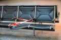 Defective broken seat secured with a red and white plastic barrier tape in the waiting area of an airport