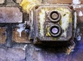 Defective old power switch in a fuse box made of rotten plastic on a brick wall Royalty Free Stock Photo
