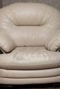 Defects on a white leather sofa. Damaged to leather furniture.