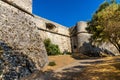 Defense walls and towers of medieval fortress Fort Carre castle in Antibes resort city onshore Mediterranean Sea in France Royalty Free Stock Photo