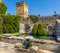 Defensive towers and fortified walls protect a secluded water garden in Cordoba, Spain