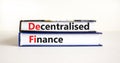 DeFi, Decentralised finance symbol. Concept words `DeFi, Decentralised finance` on books. Beautiful white table, white backgroun Royalty Free Stock Photo