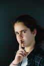 Defiant teenager with finger on lips. Royalty Free Stock Photo