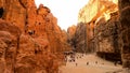 Tourists circulating inside the defile of the Treasury in Petra, Jordan.