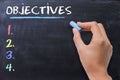 Define business or strategic objectives written by woman on chalkboard Royalty Free Stock Photo