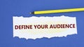 DEFINE YOUR AUDIENCE - word on a torn white paper on a blue background