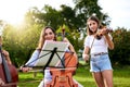 Definitely one of our most favorite pastimes. a young girl playing a violin outdoors. Royalty Free Stock Photo