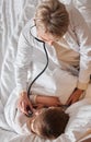 This definitely sounds like a chest infection to me. High angle shot of a doctor examine a little boy with a stethoscope Royalty Free Stock Photo