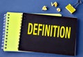 DEFINITION - word on a black notebook on a blue background Royalty Free Stock Photo