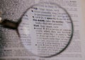 The definition of the word List in a dictionary, under magnifying glass, translator and language concept Royalty Free Stock Photo
