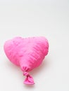 Deflate heart shape balloon in pink color isolated on white background Royalty Free Stock Photo