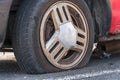 Deflated car wheel tire on wrecked car
