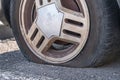 Deflated car wheel tire on wrecked car
