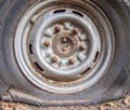 Deflated damaged tyre on car wheel Royalty Free Stock Photo
