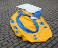 Deflated rubber on the cobblestones for sale in yellow and blue Royalty Free Stock Photo