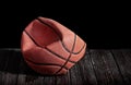 Deflated and rumpled old ball on a wooden floor