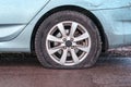 Deflated tyre damage to blue car wheel Royalty Free Stock Photo