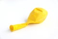 Deflated yellow balloon isolated on a white background Royalty Free Stock Photo