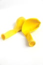 Deflated yellow balloon isolated on a white background Royalty Free Stock Photo