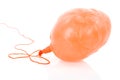 Deflated yellow balloon at a rope; over white Royalty Free Stock Photo