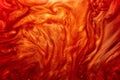 Defocus. Abstract detailed particles of red, orange, glitter flow under water. Movement of the shimmer in the water is