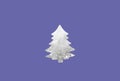 Defocus abstract paper christmas tree shaped on purple background. Art Christmas tree paper cutting design simple card