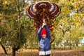 Defocus autumn people. Teen girl holding umbrella and throwing leaves. Many flying orange, yellow, green dry leaves Royalty Free Stock Photo