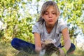 Defocus blonde little expression girl playing and caress cat, black and white small kitten. Nature blurred green summer Royalty Free Stock Photo