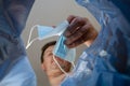 Defocus, blur, noise. Man throws medical mask into trash garbage can