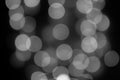 Defocus blurred circles from electric bokeh lamps, background backdrop decoration design. Black and white blurred light effect of