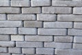 Defocus brick tiles stacked on a pallet. Gray pavement bricks for pavement road. Stack paving stones stacked in stacks